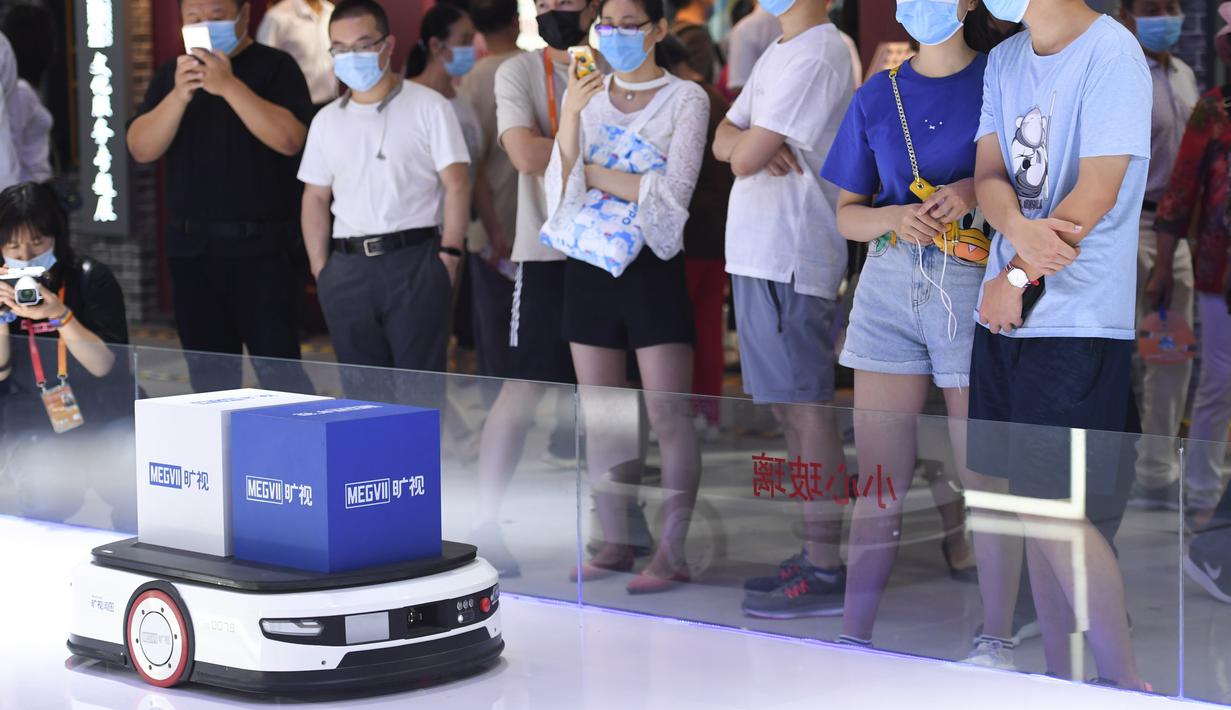 Orang-orang mengamati robot logistik pintar di area ekshibisi komprehensif dalam Pameran Perdagangan Jasa Internasional China (CIFTIS) 2020 di Beijing, ibu kota China, pada 6 September 2020. CIFTIS digelar pada 4-9 September di Beijing. (Xinhua/Ju Huanzong)