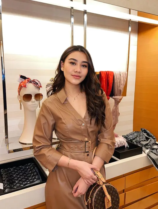 Kombinasi outfit chic dan elegan ala Aaliyah Massaid dengan padu padan leather dress warna camel dan LOUIS VUITTON Monogram Petite Boite Chapeau Bag.