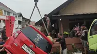 Sebuah mobil minibus milik warga terseret derasnya banjir di Kecamatan Panjang, Bandar Lampung.  Foto : (Liputan6.com/Ardi).