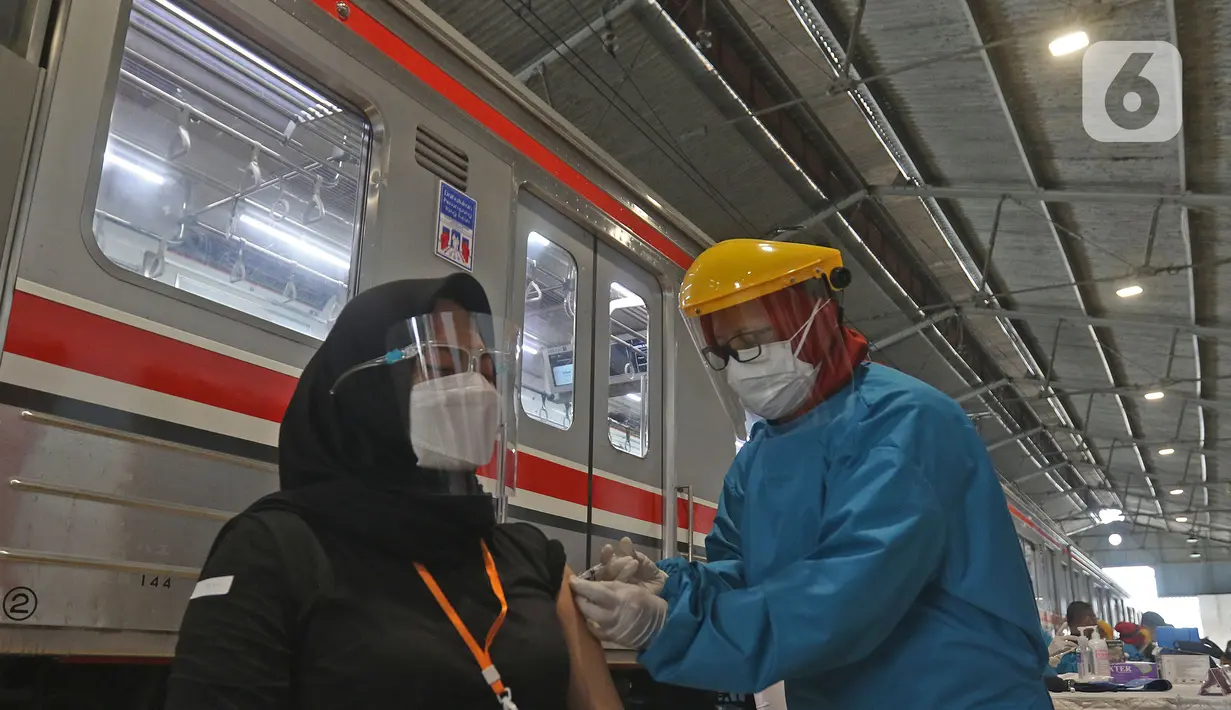 Petugas medis mennyuntikkan vaksin kepada penumpang kereta di Stasiun Bogor, Jawa Barat, Kamis (17/6/2021). Pelaksanaan vaksinasi massal di Stasiun Bogor itu menyasar petugas stasiun, pekerja di stasiun dan penumpang kereta. (Liputan6.com/Herman Zakharia)