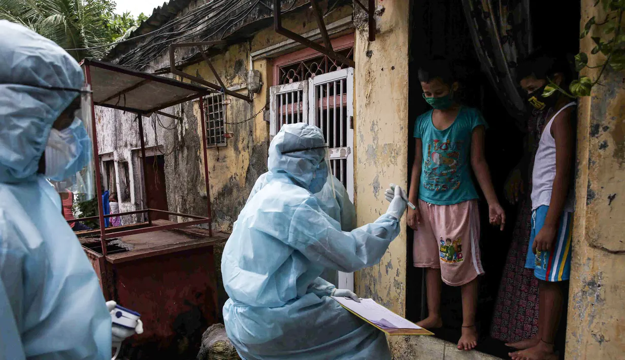 Petugas kesehatan India yang mengenakan alat pelindung diri melakukan pemeriksaan COVID-19 di kawasaan permukiman kumuh di tengah penyebaran wabah tersebut di Mumbai, India (17/6/2020). (Xinhua/Stringer)