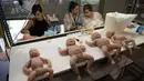Pekerja wanita Clon Factory, yang membuat boneka bayi silikon yang mirip manusia, di Kota Leioa, Spanyol Basque, Selasa (20/6). Pabrik ini khusus memproduksi bayi imitasi dari premium silikon yang biasa dipakai untuk operasi plastik. (ANDER GILLENEA/AFP)