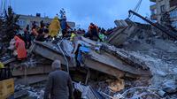 Petugas penyelamat dan sukarelawan mencari korban selamat di reruntuhan bangunan yang runtuh, di Sanliurfa, Turki, Senin 6 Februari 2023, setelah gempa bumi berkekuatan 7,8 skala Richter menghantam bagian tenggara negara tersebut. Jumlah korban tewas gabungan telah meningkat menjadi lebih dari 2.300 orang di Turki dan Suriah setelah gempa terkuat di wilayah tersebut dalam hampir satu abad terakhir. (REMI BANET/AFP)