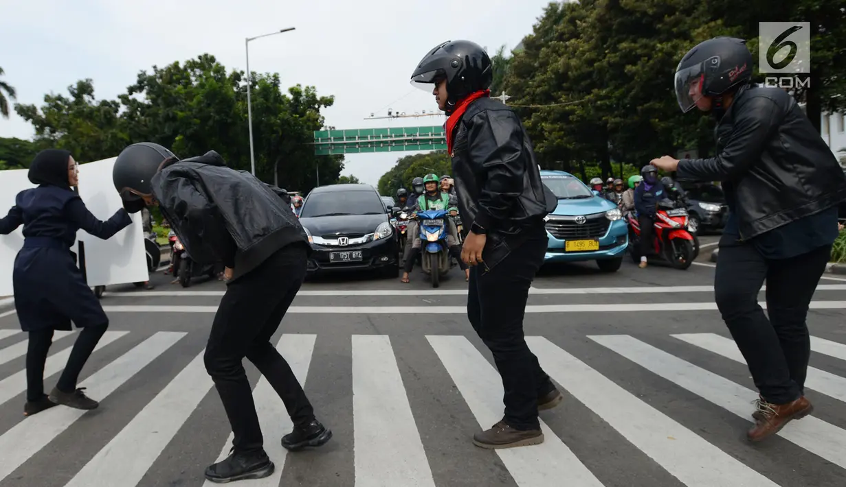 Aksi sejumlah mahasiswa dan mahasiswi saat mengampanyekan keselamatan berlalu lintas di Jakarta, Rabu (20/3). Aksi ini mengajak pengendara untuk tertib berlalu lintas dengan #SelamatDijalan. (merdeka.com/Imam Buhori)