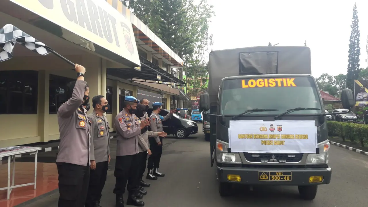 Kapolres Garut AKBP Wirdhanto Hadicaksono, didampingi perwira Polres Garut, melepas dua truk bantuan sosial (bansos) korban gunung Semeru erupsi, Selasa (7/12/2021).