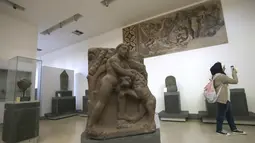 Seorang wanita mengunjungi Museum Nasional Suriah selama upacara pembukaan kembali di Damaskus, 28 Oktober 2018. Museum Nasional Suriah ini terpaksa tutup selama lebih dari enam tahun sejak konflik di Suriah pecah 2011. (Photo by LOUAI BESHARA / AFP)