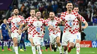 Kiper Kroasia merayakan kemenangan setelah mengalahkan Jepang di babak adu penalti pada laga 16 besar Piala Dunia 2022 yang berlangsung di Al-Janoub Stadium, Senin (05/12/2022). (AFP/Jawel Samad)