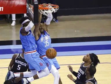 Pebasket Houston Rockets, Christian Wood, memasukan bola saat melawan Sacramento Kings pada laga NBA, Jumat (1/1/2021). Houston Rockets menang dengan skor 122-119. (AP/Richard Carson)