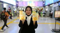 Penumpang menunjukkan dua kue kering yang dibagikan gratis di stasiun Sudirman Duku Atas Jakarta (10/4/2023). Menjelang berbuka puasa Forvita menyajikan kue kering sebanyak 2000 takjil sebagai sajian berbuka puasa bagi penumpang commuter line. (Liputan6.com)