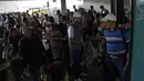 Sejumlah calon penumpang terlihat di luar bandara internasional La Aurora yang tutup akibat abu vulkanik gunung berapi Fuego di Guatemala City, Minggu (3/6). Tujuh orang tewas dan 300 lainnya terluka akibat letusan gunung berapi Fuego. (AFP/JOHAN ORDONEZ)