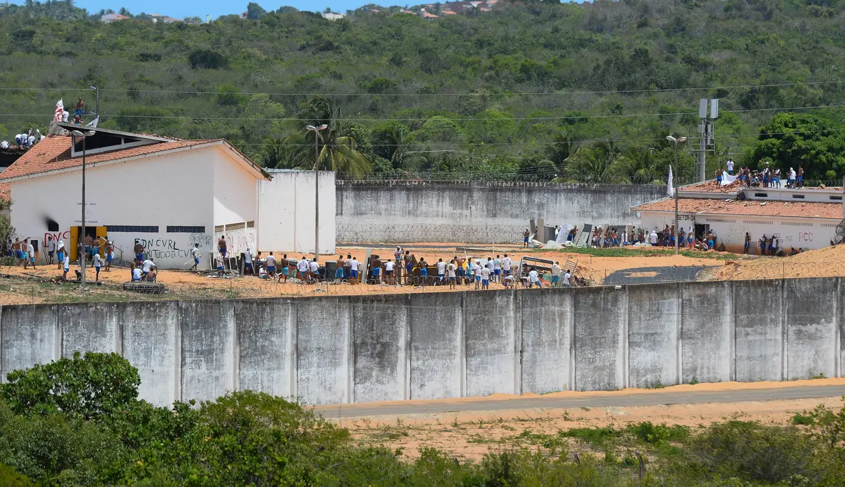Dua kubu geng narkoba saat berada di penjara Alcacuz, Rio Grande do Norte, Brasil, (17/1). Bentrokan ini berlanjut dari pembantaian beberapa hari lalu yang menewaskan 26 orang. (AFP Photo/Andressa Anholette)