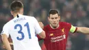 Gelandang Liverpool, James Milner berusaha merebut bola yang dibawa bek KRC Genk, Joakim Maehle pada pertandingan lanjutan Grup E Liga Champions di Stadion Anfield, Inggris (5/11/2019). Liverpool menang tipis 2-1 atas Genk. (AP Photo/Jon Super)