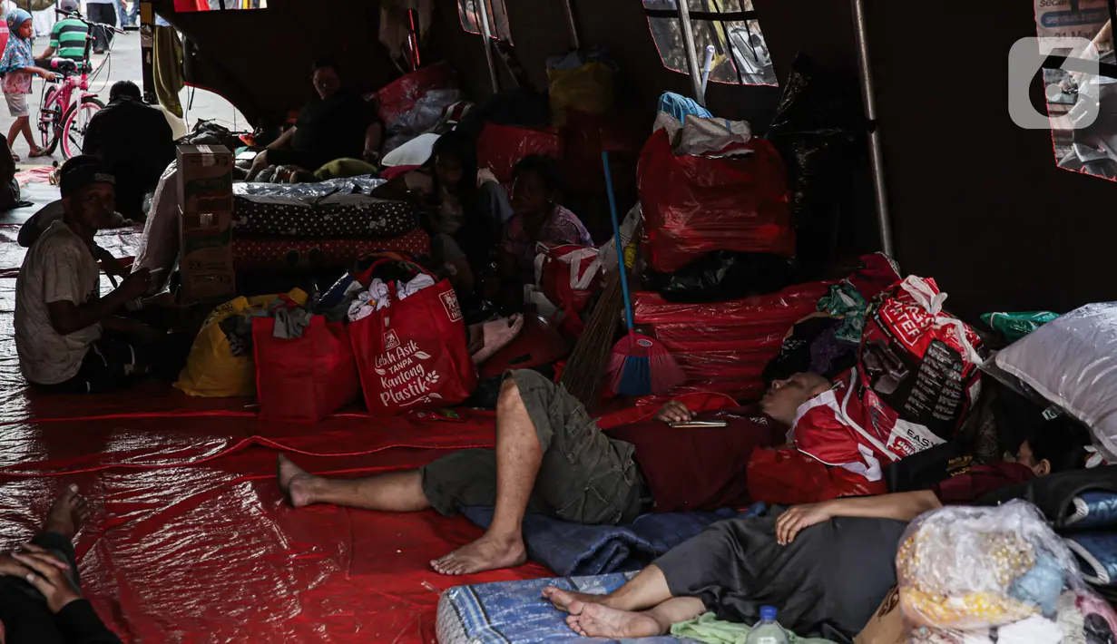 Ratusan korban kebakaran Manggarai tidur beralaskan kasur yang dijejerkan di dalam tenda. Barang-barang mereka diletakkan tak beraturan di samping kasur. (Liputan6.com/Faizal Fanani)