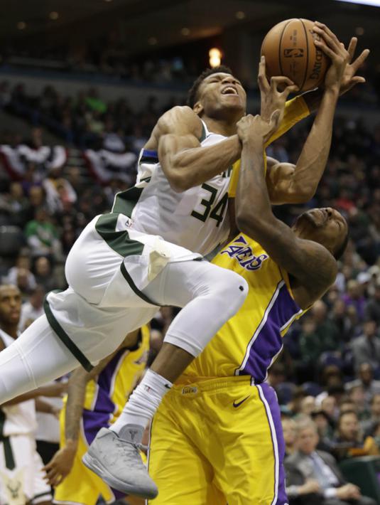 Pebasket Milwaukee Bucks, Giannis Antetokounmpo, berebut bola dengan pebasket LA Lakers, Kentavious Caldwell-Pope, pada laga NBA di Bradley Center, Minggu (12/11/2017). Bucks menang 98-90 atas LA Lakers. (AP/Darren Hauck)