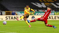 Pemain Wolverhampton Wanderers Nelson Semedo (kiri) melakukan tembakan ke gawang Liverpool pada pertandingan Liga Inggris di Stadion Molineux, Wolverhampton, Inggris, Senin (15/3/2021). Liverpool menang 1-0. (AP Photo/Jason Cairnduff,Pool)