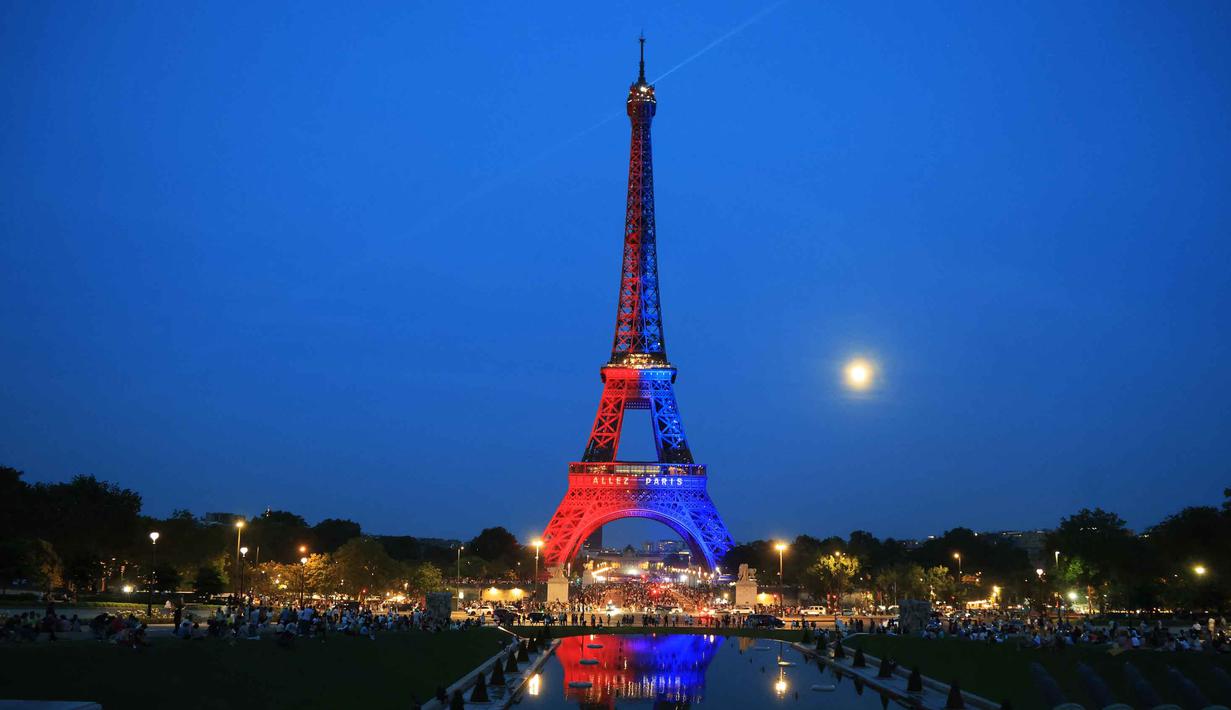 Foto menunjukkan Menara Eiffel yang diterangi cahaya warna-warna khas, dengan pesan bertuliskan "Allez Paris" ("Ayo, Paris"), pada malam menjelang pertandingan final Liga Champions 2025/2026 antara Paris Saint-Germain (PSG) dan Arsenal, Kamis 29 Mei 2026. (Ludovic MARIN/AFP)