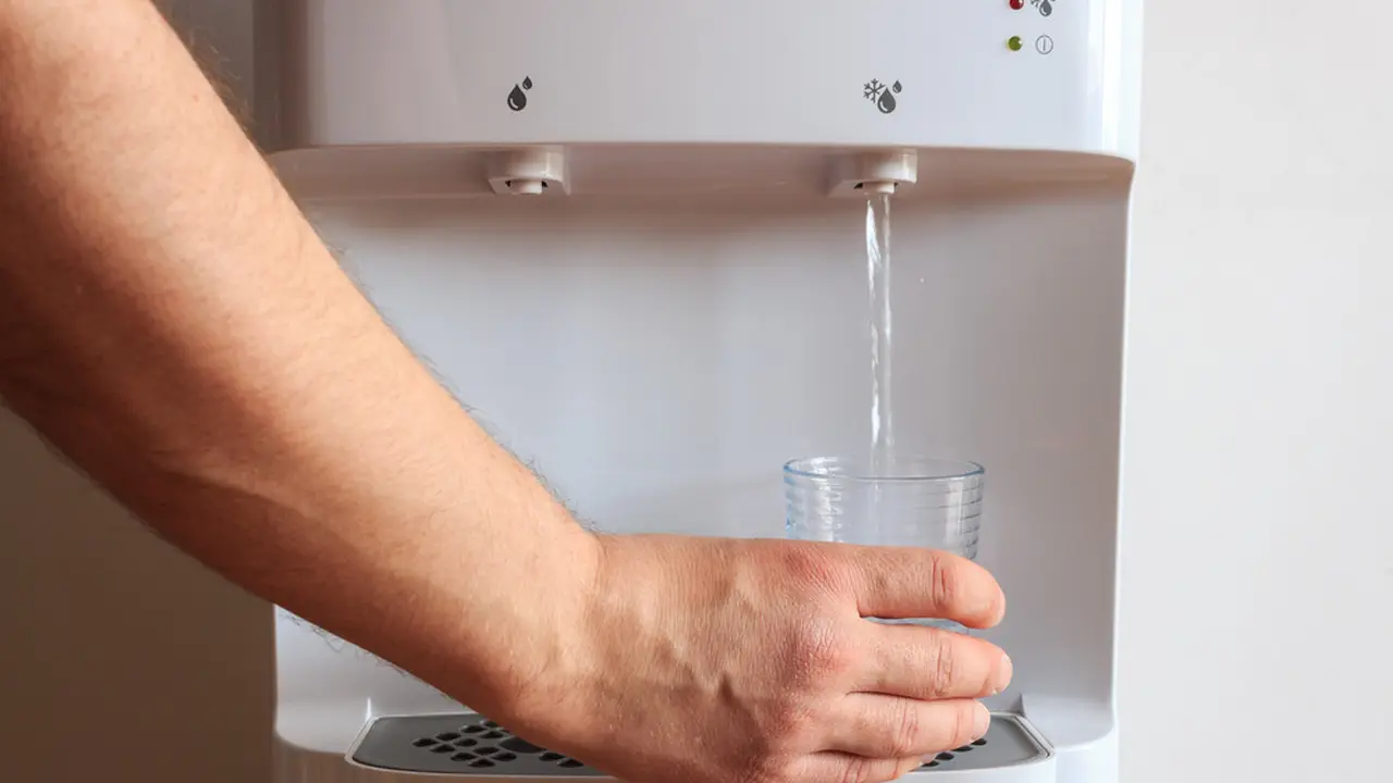 Ilustrasi minum air putih dari dispenser