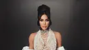 Gaun mutiara dari Schiaparelli bikin penampilan Kim Kardashian terlihat unik. Ia tampil berani dengan bikini mutiara di bagian dada dan long train coat [@kimkardashian]