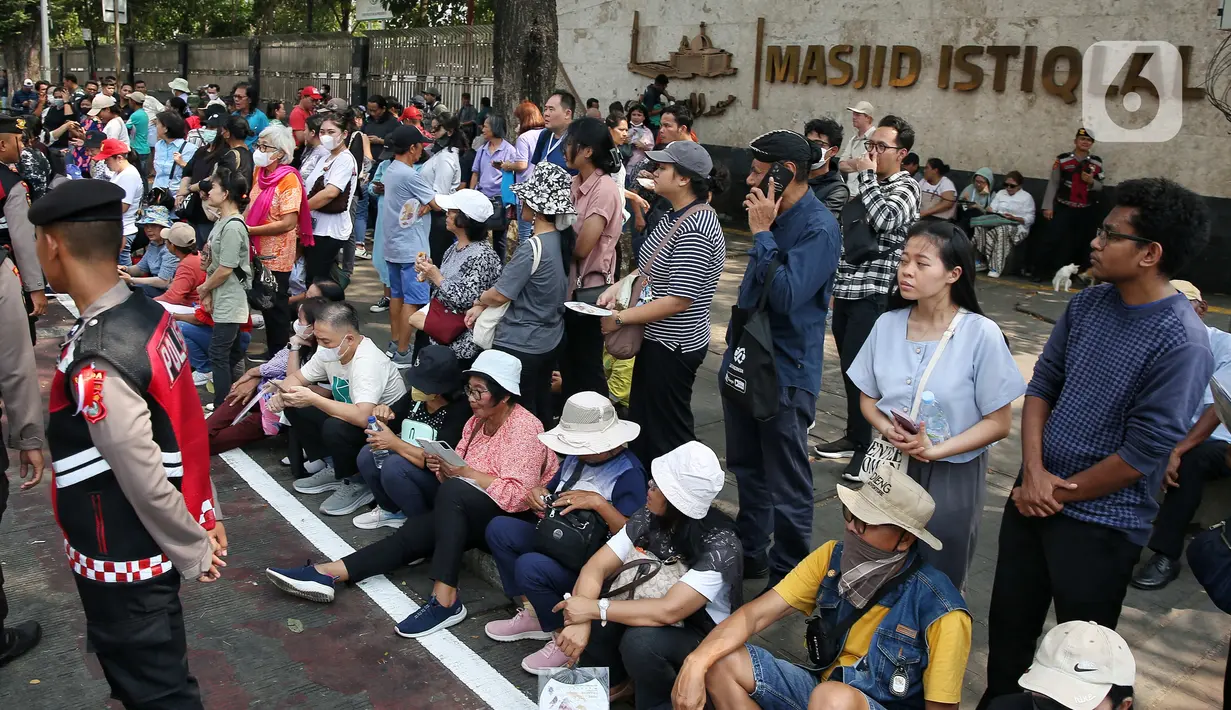 Sejumlah jemaat terlihat menanti kedatangan Paus Fransiskus di pinggir jalan di depan Gereja Katedral Jakarta. (Liputan6.com/Angga Yuniar)