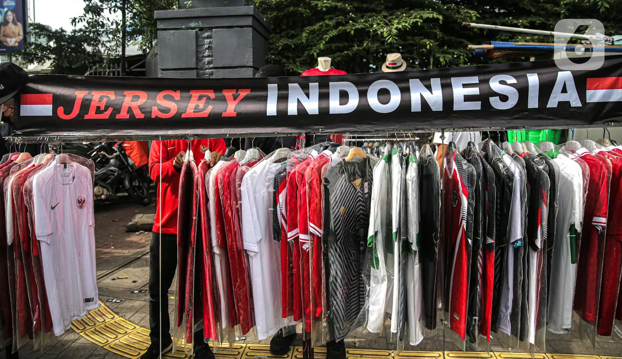 Jersey Timnas Indonesia dijual jelang pertandingan AFF 2022 antara Indonesia melawan Thailand di Stadion Gelora Bung Karno, Jakarta, Kamis (29/12/2022). Atribut timnas Indonesia seperti kaos, syal, dan topi dijual dengan kisaran harga Rp35.000 hingga Rp75.000. (Liputan6.com/Faizal Fanani)