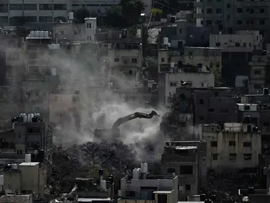 Buldoser tentara Israel menghancurkan rumah-rumah di kamp pengungsi perkotaan Palestina Nur Shams, dekat kota Tulkarem di Tepi Barat, Rabu 31 Desember 2025. Akhir Desember 2025, militer Israel kembali merobohkan sedikitnya 25 bangunan hunian yang menampung sekitar 100 keluarga. (AP Photo/Majdi Mohammed)