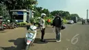 Polisi wanita (polwan) mulai mengenakan jilbab saat bertugas di pelataran Silang Monas, Jakarta, Jumat (27/3/2015). Polwan di seluruh Indonesia akhirnya diperbolehkan mengenakan jilbab. (Liputan6.com/Faizal Fanani)