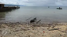 Sebuah sampan bersandar di tepi pantai yang dipenuhi sampah di Pulau Bunaken, Manado, Sabtu (17/12). Obyek wisata kelas dunia dari Sulawesi Utara itu sangat memprihatinkan saat ini. (Liputan6.com/Fery Pradolo)