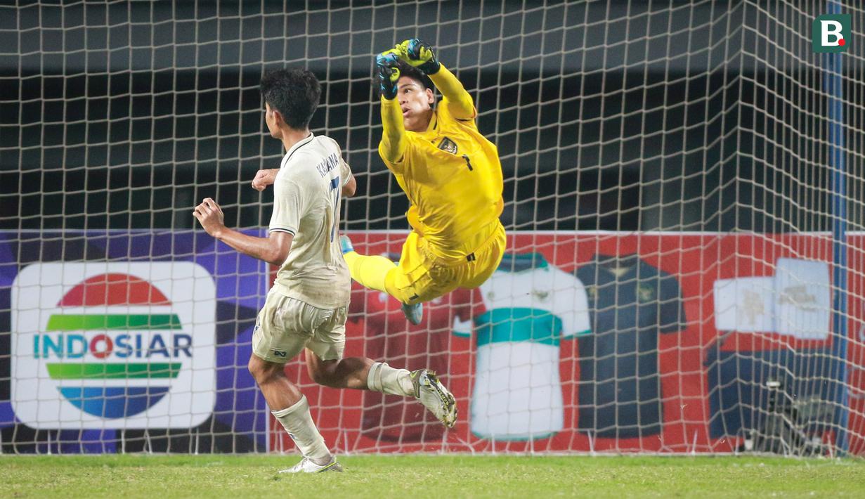 Kiper Timnas Indonesia U-19, Cahya Supriadi berusaha menghalau bola saat matchday ketiga Grup A Piala AFF U-19 2022 antara Timnas Indonesia U-19 melawan Timnas Thailand U-19 di Stadion Patriot Candrabhaga, Bekasi, Jawa Barat, Rabu (06/07/2022). (Bola.com/Bagaskara Lazuardi)