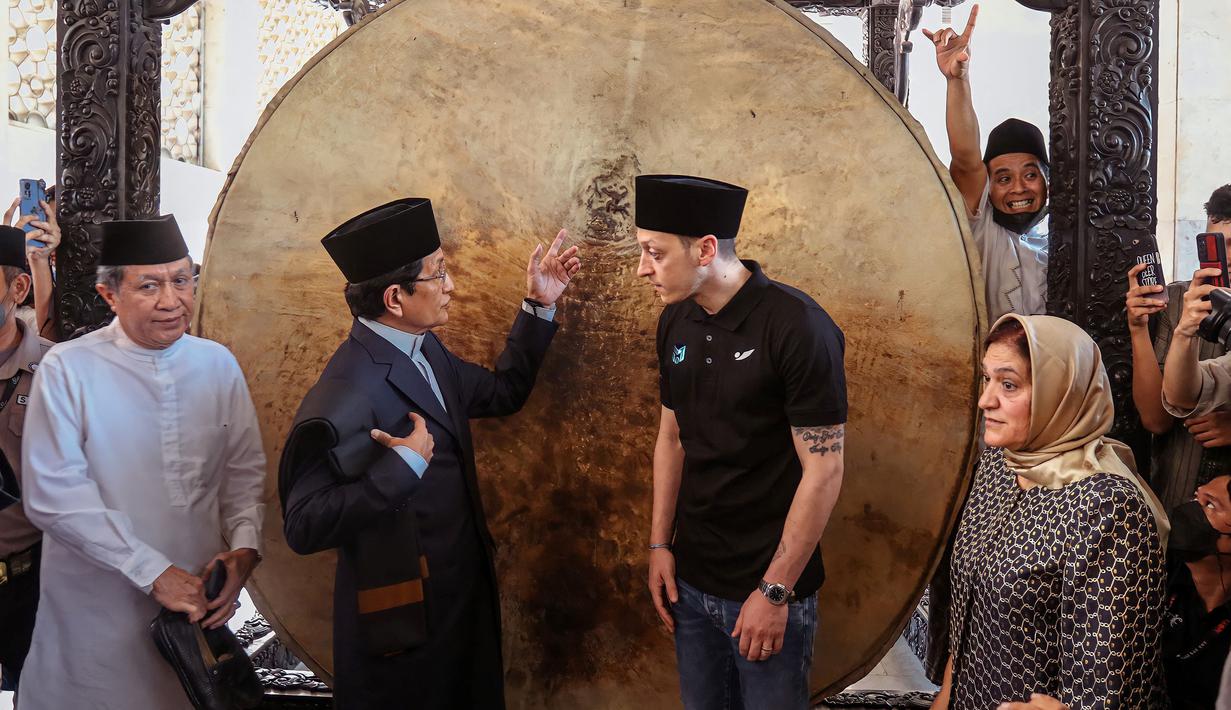 Mantan pemain Timnas Jerman, Mesut Ozil (tengah kanan) bercengkrama dengan imam besar Masjid Istiqlal, Nasaruddin Umar saat mengunjungi Masjid Istiqlal, Jakarta, pada 27 Mei 2022. (AFP/Popoh Ria)