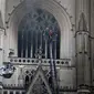 Petugas pemadam kebakaran tengah berupaya untuk memadamkan kobaran api di Katedral Saint Pierre et Saint Paul, Nantes, Prancis barat, Sabtu (18/7/2020). (Photo credit: AP Photo/Romain Boulanger)