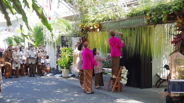 Jokowi melakukan pemasangan bleketepe yang terbuat dari anyaman daun kelapa dipasang di atas pintu masuk rumah (Liputan6.com/Fajar Abrori)