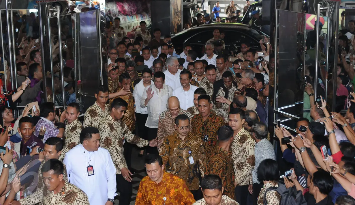 Ratusan warga menyambut kedatangan Presiden RI Joko Widodo dan Presiden Republik Filipina ‎Rodrigo Roa Duterte di Pasar Blok A Tanah Abang Jakarta, Jumat (9/9). Ini kunjungan kenegaraan pertama Duterte. (Liputan6.com/Helmi Fithriansyah)