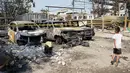 Seorang anak berjalan melintasi sejumlah mobil yang hangus terbakar di lahan parkir Jalan Budi Mulia Utara, Pademangan, Jakarta Utara, Rabu (24/7/2019). Kebakaran menghanguskan 14 mobil, 5 sepeda motor, dan 3 bedeng serta seorang warga mengalami luka bakar. (Liputan6.com/Immanuel Antonius)