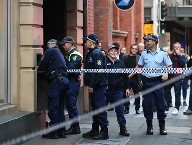 Polisi menyelidiki daerah di sekitar lokasi kejadian setelah seorang pria menikam seorang wanita dan berusaha menikam orang lain di pusat kota Sydney (13/8/2019). Pelaku penikaman berhasil ditangkap polisi setelah sejumlah warga melawan . (AFP Photo/Saeed Khan)