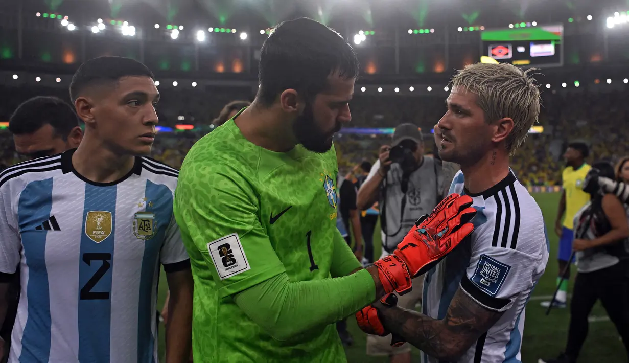 Adu argumentasi terjadi antara kiper Timnas Brasil, Allison Becker (tengah), dengan pemain Timnas Argentina Rodrigo De Paul saat pertandingan Kualifikasi Piala Dunia 2026 Zona CONMEBOL yang berlangsung di Maracana Stadium, Rio de Janeiro, Rabu (22/11/2023) pagi WIB. (AFP/Carl De Souza)