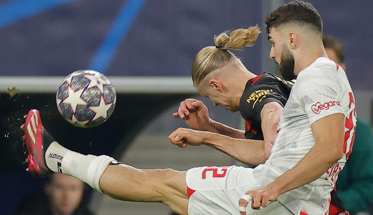 Pemain Manchester City, Erling Haaland berebut bola dengan bek RB Leipzig, Josko Gvardiol (kanan) dalam pertandingan leg pertama babak 16 besar Liga Champions 2022/2023 antara RB Leipzig melawan Manchester City yang berlangsung di Red Bull Arena, Kamis (23/2/2023). (AFP/Odd Andersen)
