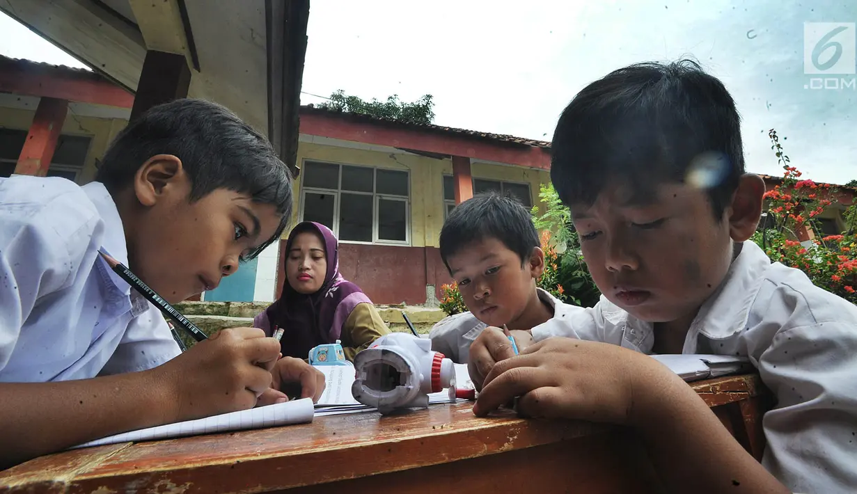 Murid SDN Mutiara mengikuti aktivitas belajar di dalam tenda darurat di Kampung Pasir Bayur, Cibeber II, Bogor, Selasa (3/4). Mereka terpaksa belajar di luar karena bangunan sekolah yang berdiri sejak tahun 2009 itu rusak berat. (Merdeka.com/Arie Basuki)