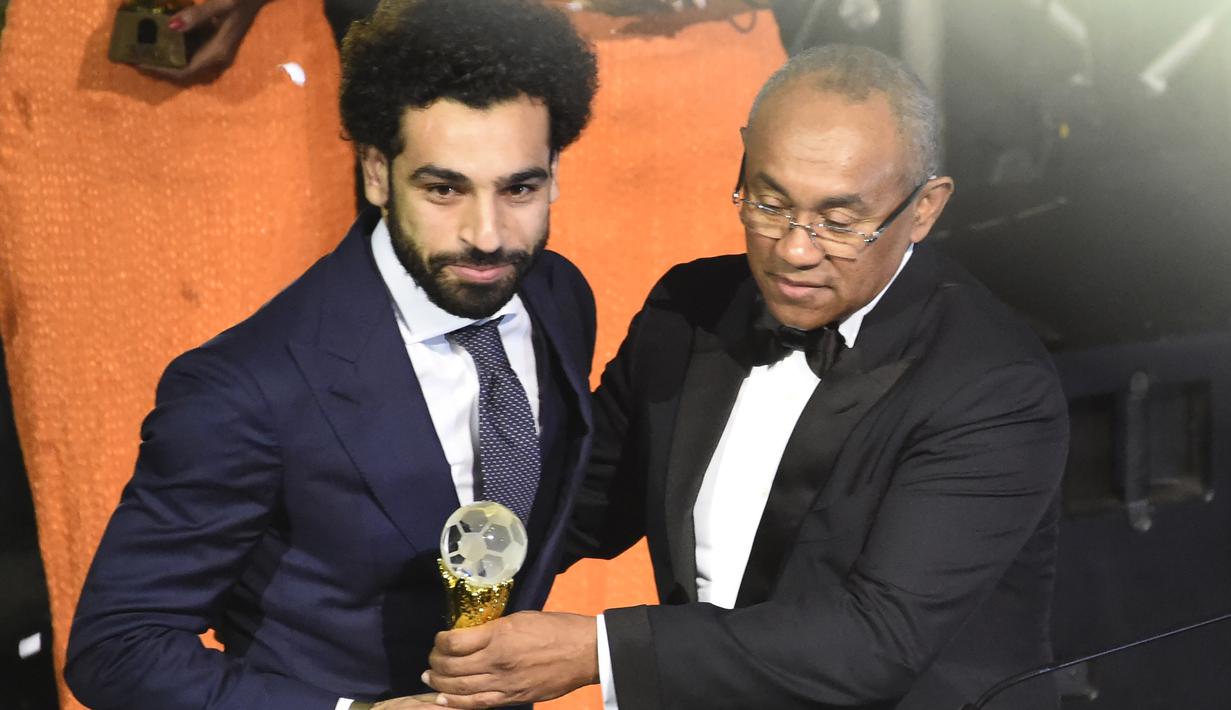 Mohamed Salah menerima trofi Pemain Terbaik Afrika 2017 dari Presiden CAF, Ahmad Ahmad (kanan) pada ajang The African Footballer of the Year Award  di Accra International, Accra, (4/1/2018). Salah mengalahkan Sadio Mane. (AFP/Pius Utomi Ekpei)