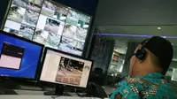 Petugas sedang memberikan informasi melalui CCTV di ruang Network Operating Center (NOC) Unit Pelayanan Sistem Pengendali Lalu Lintas (UP SPLL) Dishub DKI Jakarta. (Herdi Muhardi)