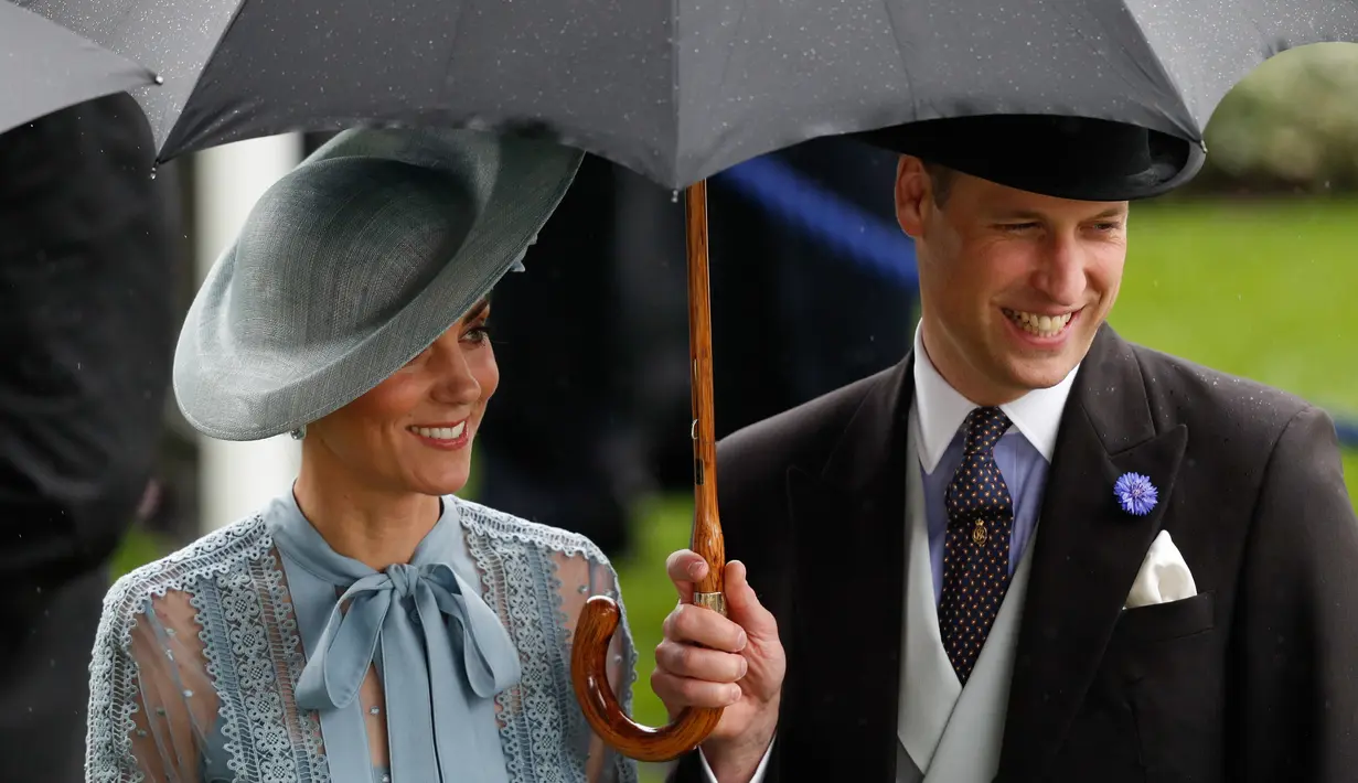 Duchess of Cambridge Kate Middleton bersama suaminya Duke of Cambridge Pangeran William mengenakan payung saat menghadiri ajang pacuan kuda Royal Ascot di Ascot, Inggris, Selasa (18/6/2019). (ADRIAN DENNIS/AFP)