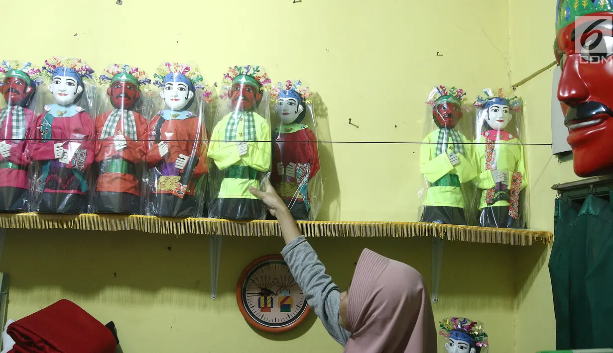 Perajin, merapikan miniatur ondel-ondel dari botol plastik di rumah produksi Kramat Jati, Jakarta, Rabu (28/11). Miniatur yang terbuat dari plastik diproduksi 50-80 buah dengan omset 5-8 Juta perbulan. (Liputan6.com/Herman Zakharia)