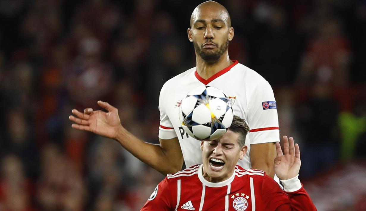 Duel pemain Sevilla, Steven N'Zonzi (atas) dan pemain Bayern, James Rodriguez pada leg pertama Liga Champions di Sanchez Pizjuan stadium, Seville, (3/4/2018) waktu setempat. Beyern menang 2-1. (AP/Miguel Morenatti)