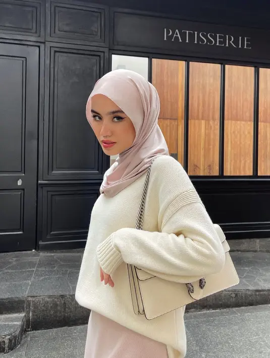 Gaya hijab ini kini menjadi tren di media sosial dan dikenal dengan julukan hijab atau pashmina “meleyot” karena memberikan efek lengkungan natural yang membingkai wajah. [@sashfir].