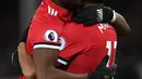 Striker Manchester United, Anthony Martial berpelukan dengan Paul Pogba merayakan gol pertama untuk timnnya saat melawan Everton dalam pertandingan Liga Inggris di Goodison Park, Liverpool (1/1). (AFP Photo/Paul Ellis)