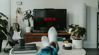 Watching Netflix on TV (Photo by Mollie Sivaram on Unsplash)