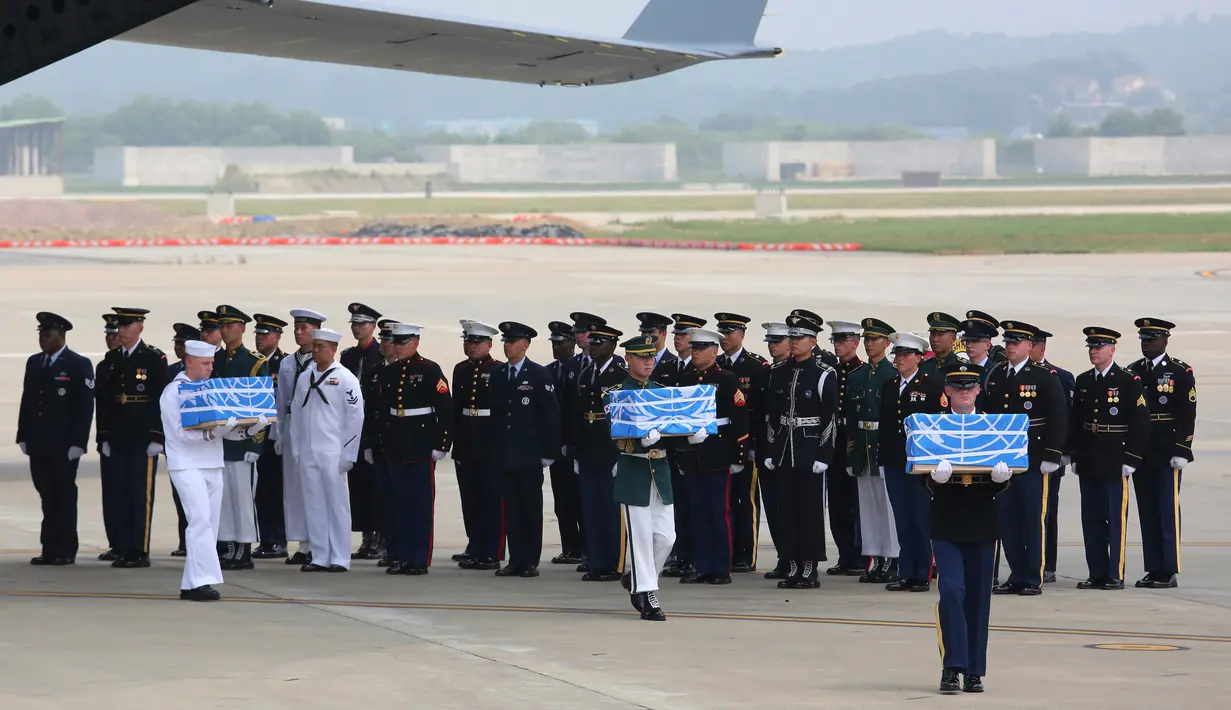Pasukan PBB membawa kotak berisi jenazah yang diyakini sebagai tentara Amerika Serikat (AS) yang tewas selama Perang Korea pada tahun 1950-1953 di Pangkalan Udara Osan, Pyeongtaek, Korea Selatan, Jumat (27/7). (AP Photo/Ahn Young-joon, Pool)