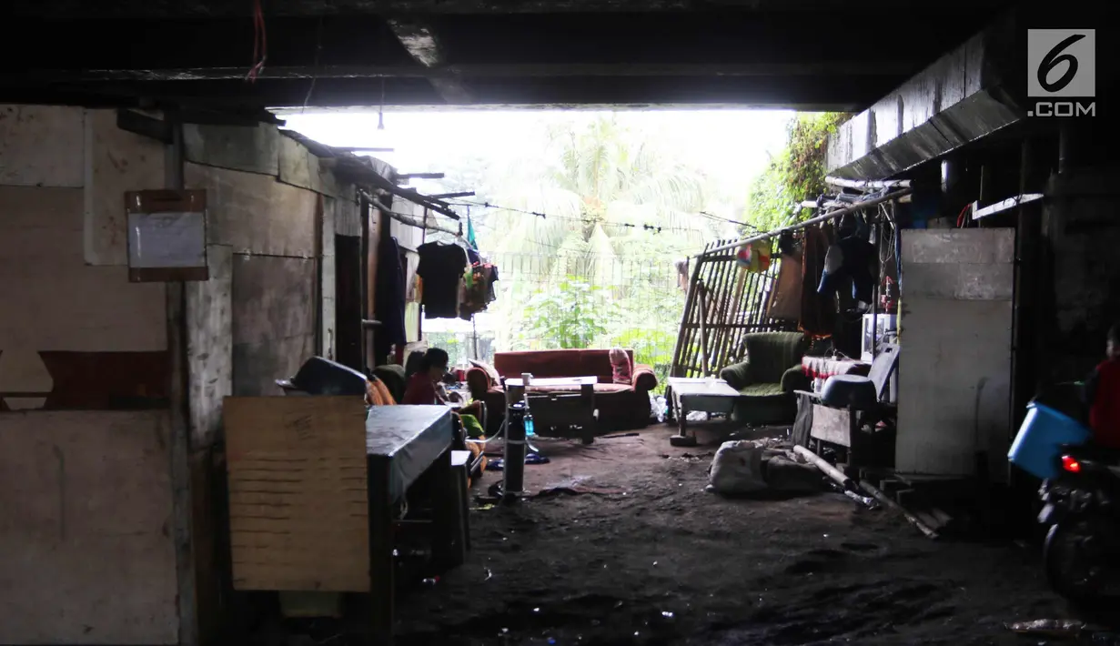 Warga beraktivitas di permukiman kolong Jalan Tol Pelabuhan, Tanjung Priok, Jakarta, Senin (23/4). Mahalnya harga hunian di Ibu Kota membuat mereka tinggal di kawasan tersebut meski dengan kondisi lingkungan kumuh dan kotor. (Liputan6.com/Arya Manggala)