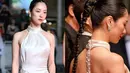 Jeon Yeo Been bersama Krystal Jung melakukan debut bersama di Cannes Film Festival 2023. Ia tampil mengenakan halter-neck backless dress berwarna putih satin yang menawan. Di bagian belakang gaunnya memiliki garis lurus taburan berlian yang cantik. Penampilan Yeo Been memukau dengan rambut yang ditata sleek-look, dikepang satu dan diikat pony-tail. Foto: Instagram.