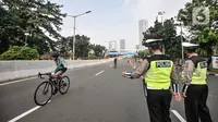 Petugas Dishub dan kepolisian saat menjaga jalannya uji coba lintasan Road Bike di JLNT Kampung Melayu-Tanah Abang, Jakarta, Minggu (23/5/2021). Uji coba lintasan Road Bike tersebut sebagai langkah untuk memfasilitasi arena bagi para pesepeda balap di Ibu Kota. (merdeka.com/Iqbal S Nugroho)