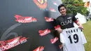 Salah satu fans Manchester United dengan bangga menunjukkan jersey bertanda tangan Dwight Yorke (Liputan6.com/Helmi Fithriansyah)